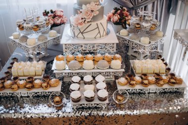 Güzel masa. Böğürtlenli kremalı kek ve kek. Şekerli masa, şeker, açık büfe. Parti şekerlemeleri için tatlı masası. Kapatın. Restoranda dekore edilmiş parti resepsiyonu. Çikolata