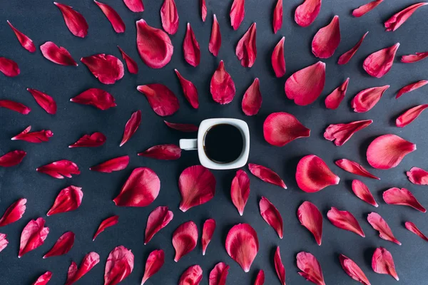 Red petals around a cup of coffee pattern