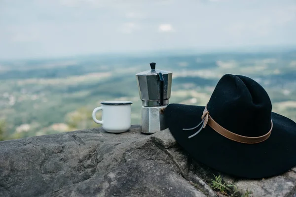 coffee  the outdoors. Adventure, travel, tourism and camping concept. Hiker drinking tea from mug at camp