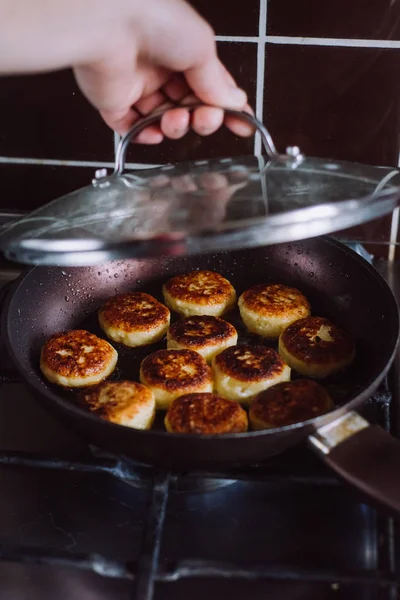 Frying pancake curd in a frying pan