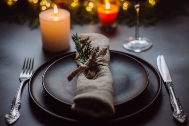 Yılbaşı süsleri ve garland, mumlar, Bijuteri, yeşil çam dalları olan tablo