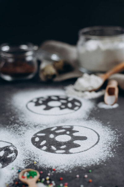 Ingredients for donuts baking. Spoon with flour, dishes, eggs, sugar  on a grey background.Bakery background frame. Top view, copy space.