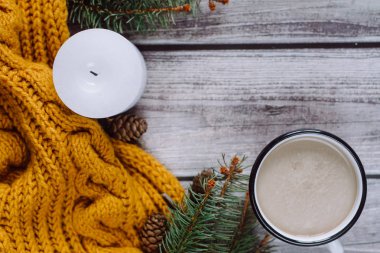 Süt, mum, darbe, çam dalları ve ahşap masa üzerinde sıcak turuncu eşarp ile kahve fincan. Kış konsepti. Düz yatıyordu, en iyi görünümü. 