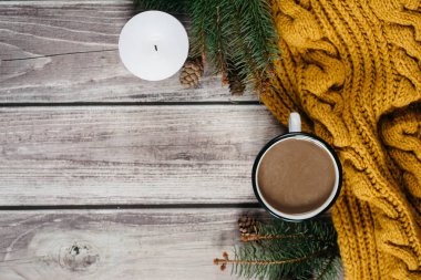 Süt, mum, darbe, çam dalları ve ahşap masa üzerinde sıcak turuncu eşarp ile kahve fincan. Kış konsepti. Düz yatıyordu, en iyi görünümü. 