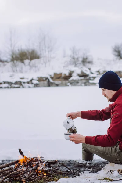 Uomo Viaggiante Siede Vicino Fuoco Del Campo Inverno Versa Caffè — Foto Stock