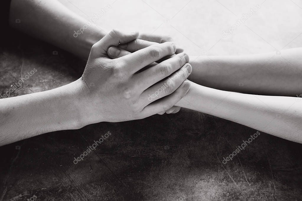 Close up view of couple holding hands to take care and help each other. Help and sharing ideas