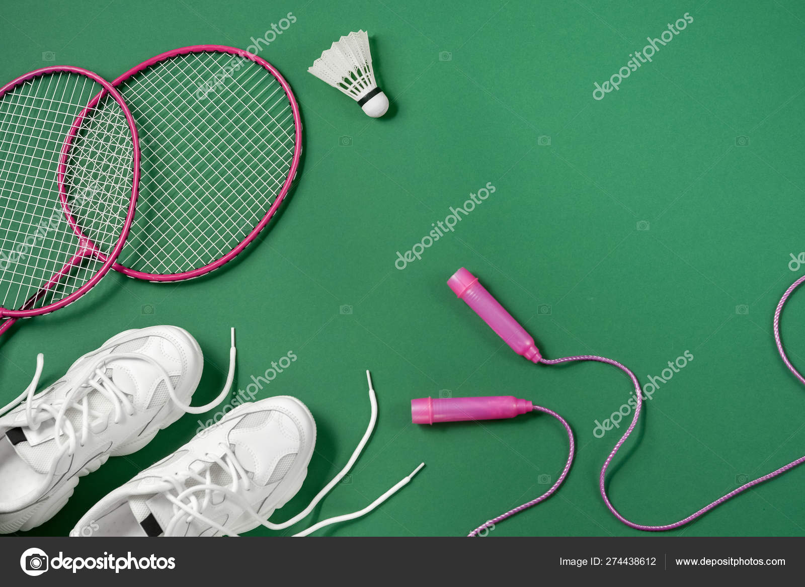 Sports flat lay with shuttlecock and badminton racket, skipping rope,  sneakers on green background. Fitness, sport and healthy lifestyle concept.  Stock Photo by ©JuraJarema 274438612