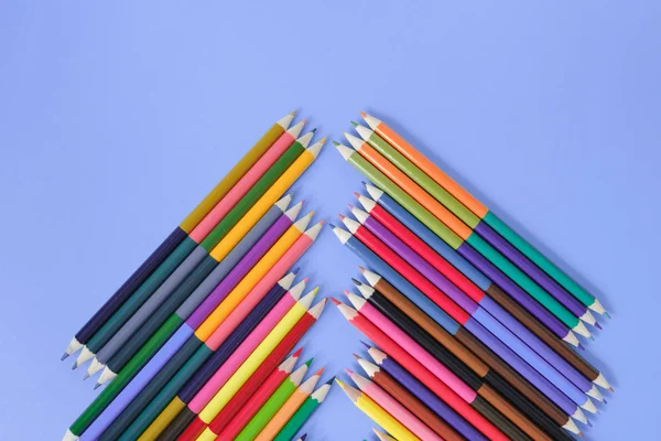 Vissza az iskolai koncepcióhoz. A kék háttéren elszigetelt színes ceruzák képek closeup képei. Lapos feküdt, felülnézet, másolási tér. — Stock Fotó
