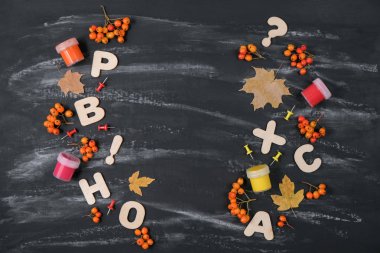 Okul konseptine geri dönelim. Siyah Masa arka planda renkli kalemler, Rowan, guaj ve kurutulmuş akçaağaç yaprakları ve ofis malzemeleri. Düz yatıyordu, üst görünüm, kopya alanı.