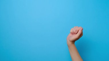 El hareketi. Fotokopi alanını gösteren kadın parmağını kapat, reklam için fotokopi alanı olan mavi stüdyo arka planında izole edilmiş. Reklam alanı, model.