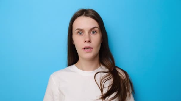 Shocked Brunette Girl Isolated Blue Studio Background Looking Camera Big — Stock Video