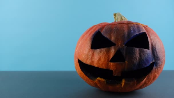 Close Front View Big Spooky Pumpkin Isolated Blue Grey Studio — Stock Video