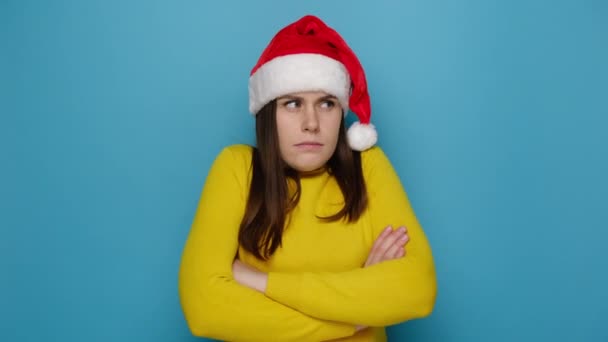 여성이 우울하게 표정으로 카메라를 있는데 모욕받거나 느낌이 스웨터와 크리스마스 모자를 — 비디오