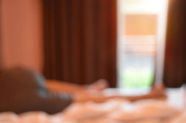 Arka plan bulanıklık, sabah görünümü penceresi ve metin için boş yer yatakta adam.