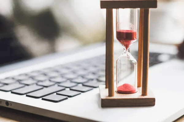 Zand klok timer op laptop. symbool van tijd — Stockfoto