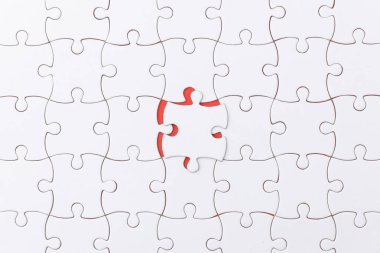 unfinished jigsaw puzzle texture on red background. connection concept. idea concept.association concept clipart