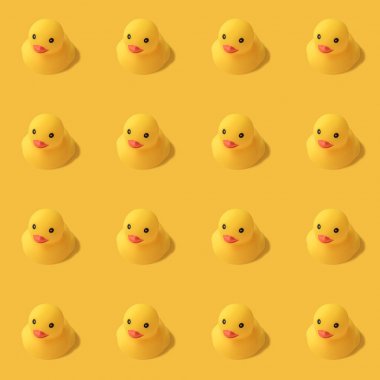 repeatable pattern of yellow rubber duck on yellow background Modern style. creative photography. clipart