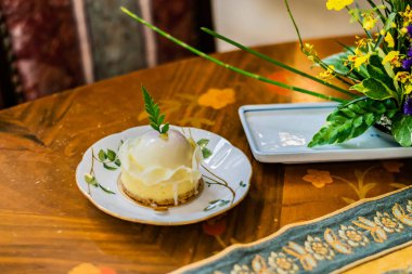 Beyaz çikolata Berry pastayla çeşitli lüks masa örtüsü ve ahşap masa beyaz tabakta servis. Arka plan bulanık ile seçici odak