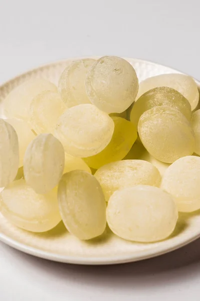 Lemon candy on a white saucer