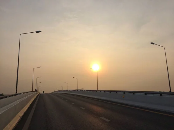 The morning sun on the road on the bridge every day