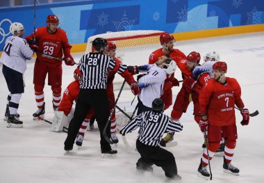 Tarihleri, Güney Kore - 17 Şubat 2018: Takım Amerika Birleşik Devletleri (beyaz içinde)--dan Rusya Erkekler Buz hokeyi ön takım olimpik atlet karşı eylem oyun 2018 Kış Olimpiyat Oyunları, yuvarlak