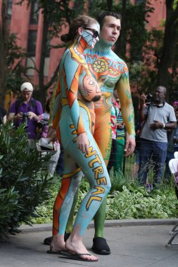 NEW YORK - JULY 14, 2018: Artists paint  fully nude models of all shapes and sizes during 5th NYC Body Painting Day featuring artist Andy Golub on Washington Square in New York clipart