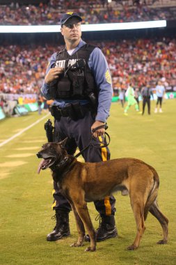 EAST RUTHERFORD, NJ - JULY 25, 2018: New Jersey State Police K-9 unit provides security during 2018 International Champions Cup game Manchester City vs Liverpool FC at MetLife stadium clipart