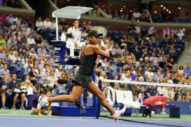 NEW YORK - SEPTEMBER 6, 2018: Professional tennis player Naomi Osaka in action during her 2018 US Open semi-final match at Billie Jean King National Tennis Center clipart