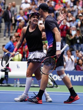 NEW YORK - SEPTEMBER 8, 2018: 2018 US Open mixed doubles champions Bethanie Mattek-Sands of USA and Jamie Murray of Great Britain celebrate victory after final match at National Tennis Center in NY clipart