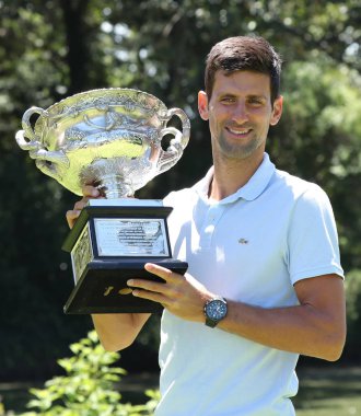 MELBOURNE, AUSTRALIA - JANUARY 28, 2019: 2019 Australian Open champion Novak Djokovic of Serbia posing with Australian Open trophy after his victory at Royal Botanic Gardens Victoria in Melbourne clipart