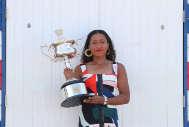 MELBOURNE, AUSTRALIA - JANUARY 27, 2019: 2 times Grand Slam Champion Naomi Osaka of Japan posing with Australian Open trophy at Brighton Beach in Melbourne after her victory at 2019 Australian Open clipart