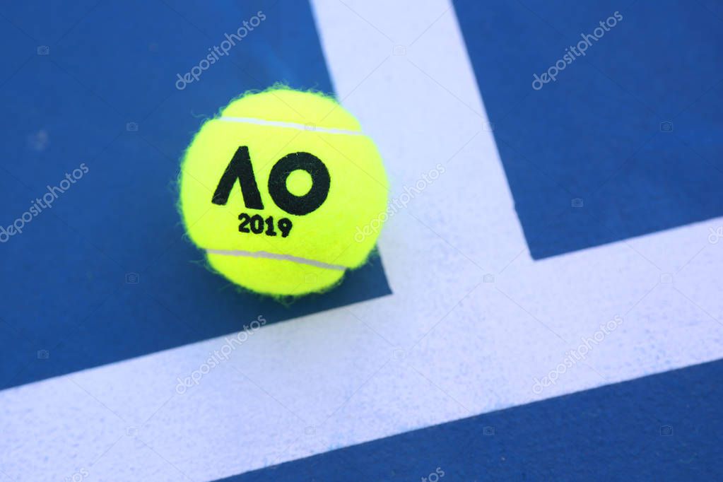 MELBOURNE, AUSTRALIA - JANUARY 23, 2019: Dunlop tennis ball with Australian Open logo on tennis court at Australian tennis center in Melbourne Park
