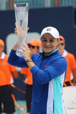 MIAMI GARDENS, FLORIDA - MARCH 30, 2019: Professional tennis player Ashleigh Barty of Australia posing with trophy after her win at 2019 Miami Open final match at the Hard Rock Stadium in Miami Gardens clipart