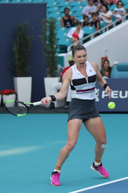 MIAMI GARDENS, FLORIDA - MARCH 27, 2019: Grand Slam Champion Simona Halep of Romania in action during her quarter-final match at 2019 Miami Open at the Hard Rock Stadium in Miami Gardens, Florida