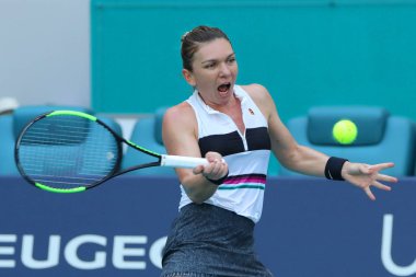 MIAMI GARDENS, FLORIDA - MARCH 27, 2019: Grand Slam Champion Simona Halep of Romania in action during her quarter-final match at 2019 Miami Open at the Hard Rock Stadium in Miami Gardens, Florida