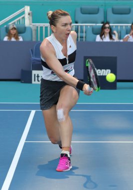 MIAMI GARDENS, FLORIDA - MARCH 27, 2019: Grand Slam Champion Simona Halep of Romania in action during her quarter-final match at 2019 Miami Open at the Hard Rock Stadium in Miami Gardens, Florida