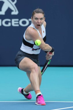 MIAMI GARDENS, FLORIDA - MARCH 27, 2019: Grand Slam Champion Simona Halep of Romania in action during her quarter-final match at 2019 Miami Open at the Hard Rock Stadium in Miami Gardens, Florida