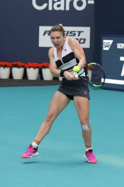 MIAMI GARDENS, FLORIDA - MARCH 27, 2019: Grand Slam Champion Simona Halep of Romania in action during her quarter-final match at 2019 Miami Open at the Hard Rock Stadium in Miami Gardens, Florida
