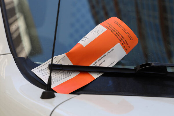 CHICAGO, ILLINOIS - MARCH 12, 2019: Illegal Parking Violation Citation On Car Windshield in Chicago