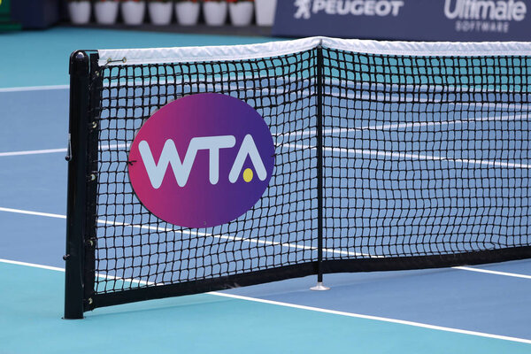 MIAMI GARDENS, FLORIDA - MARCH 27, 2019: WTA logo at tennis court net during 2019 Miami Open at the Hard Rock Stadium in Miami Gardens, Florida