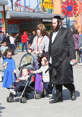Brooklyn, New York - 23 Nisan 2019: Yahudi ortodoks ailesi Brooklyn, New York'taki Coney Adası'nda Hamur Burada Hamur İzinde
