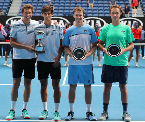 MELBOURNE, AUSTRALIA - JANUARY 27, 2019: Grand Slam champions Nicolas Mahut FRA, P H Herbert FRA, Henri Kontinen FIN John Peers AUS during trophy presentation after 2019 Australian Open final match