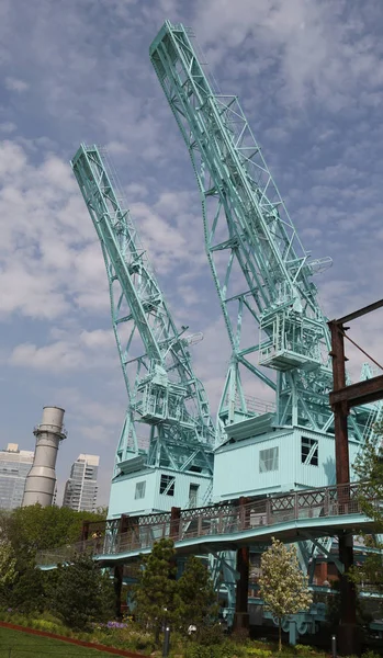 Turquoise painted Gantry Cranes in Domino Park, a relic from the Domino Sugar Factory in Williamsburg, Brooklyn