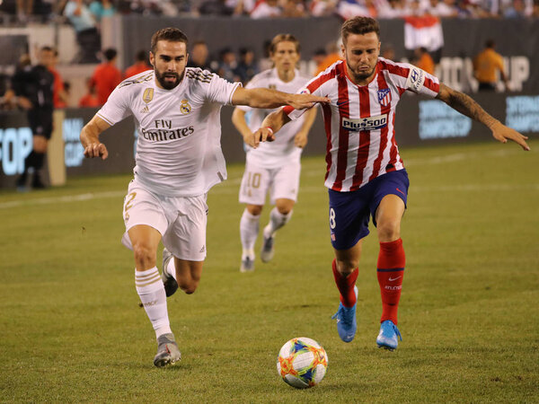 EAST RUTHERFORD, NJ - JULY 26, 2019: Dani Carvajal of Real Madrid #2 (L) and Saul Niguez of Atletico de Madrid in action during match in the 2019 International Champions Cup at MetLife stadium. 