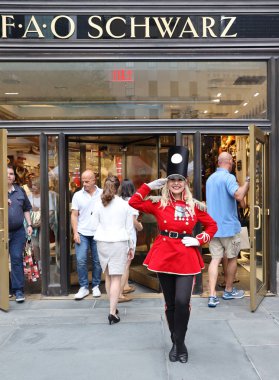 NEW YORK - JULY 18, 2019: A doorman dressed as a toy soldier stands outside newly reopened the FAO Schwarz flagship store at Rockefeller Plaza in Midtown Manhattan clipart