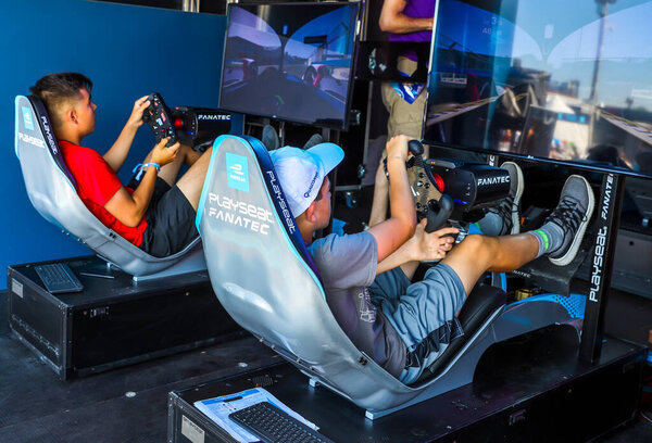 NEW YORK - JULY 13, 2019: Gamers enjoy Playseat Formula E new racing simulator inside the Gaming Arena during 2019 New York City E-Prix at Red Hook in Brooklyn
