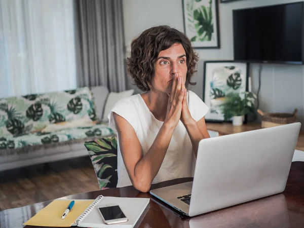 woman with laptop working at home, home office and quarantine concept