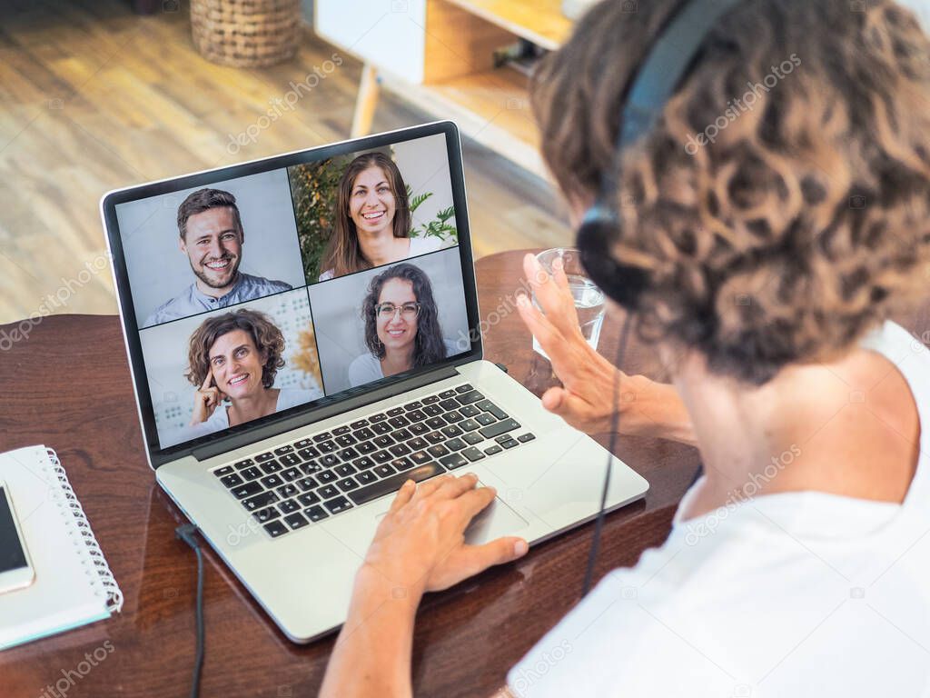 woman with laptop having video chat with friends, home office and quarantine concept