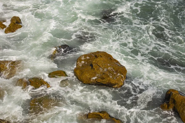 Dalgalar bir fırtına sırasında. Yukarıdan görüntüleyin. Kırmızı kod. Bulgaristan'ın Karadeniz kıyısında bekletin. Elemental kuvvet. Dalgalar kayalar karşı çökmesini.