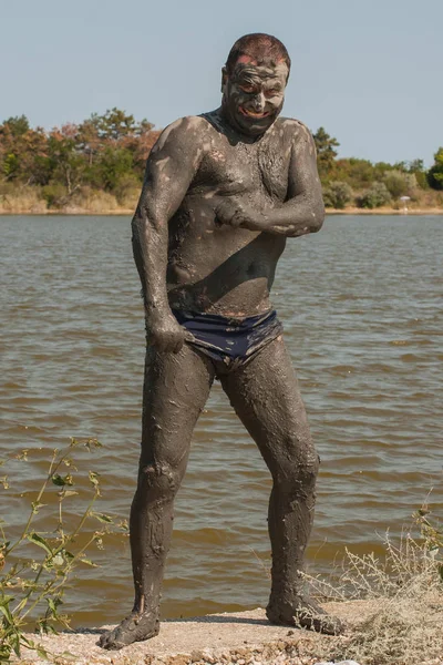 Mud Spa treatments on the Black sea coast. A man is vacationing in Bulgaria - as he can. Soiled men in full growth.